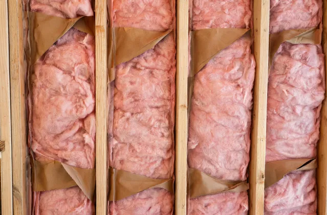 Residential wall cavities filled with fiberglass batts